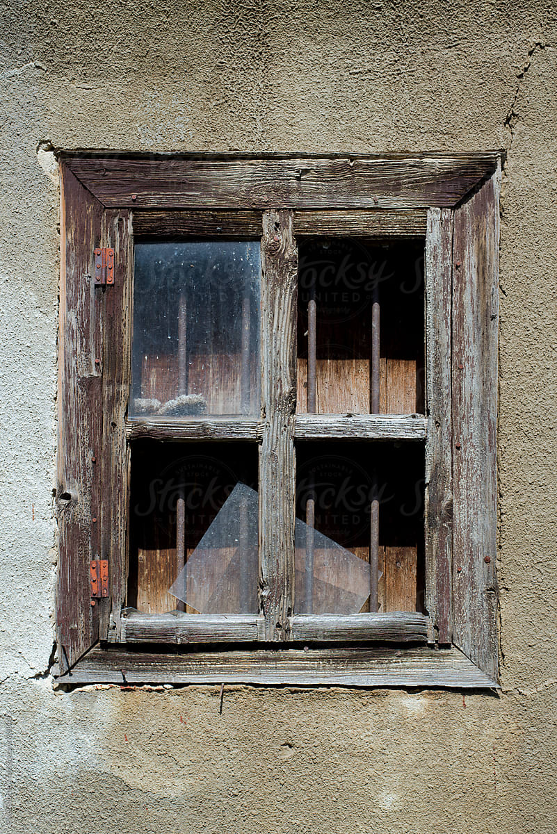 Old broken window with bars