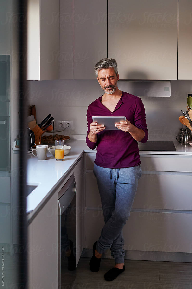 Man using a tablet over breakfast