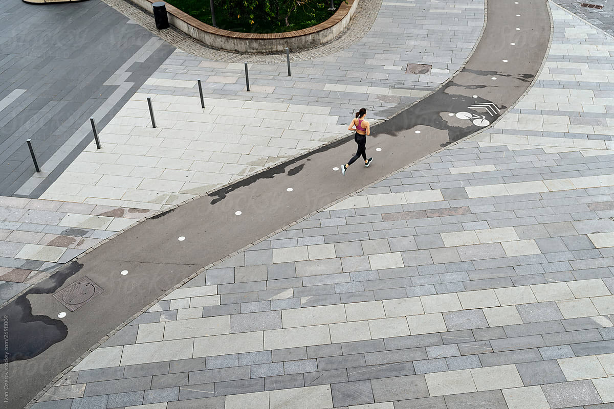 Woman running on street bicycle lane