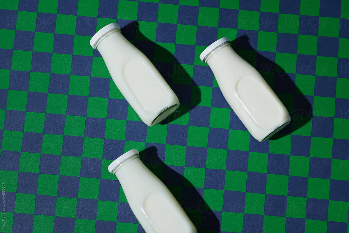Glass Milk Bottle on checkered background top view