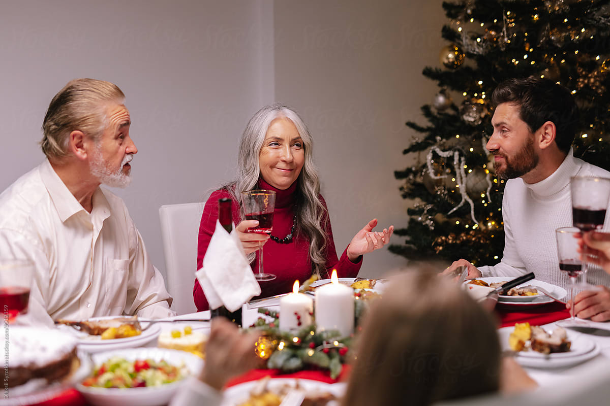 Discuss  conversation Xmas tree family toasting wine celebration