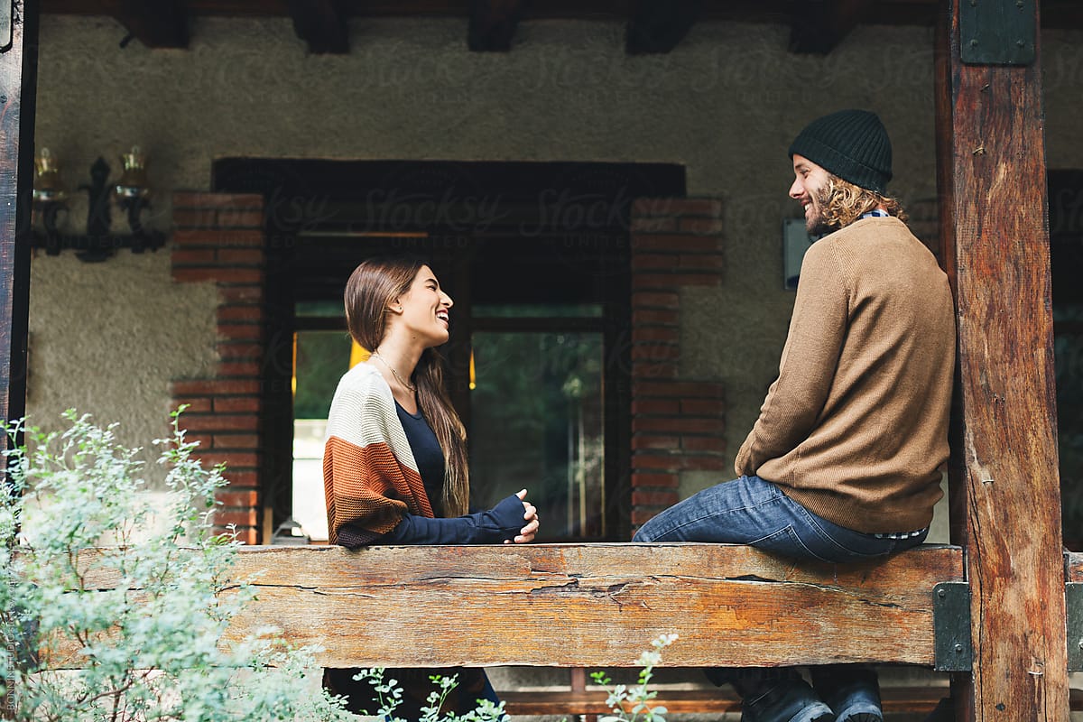Couple Talking In The Porch Of A Rural Home By Stocksy Contributor