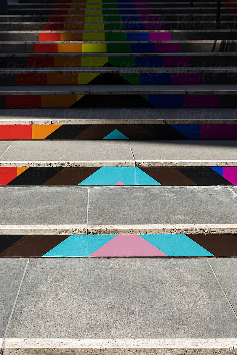 City stairs decorated with the colors of the LGBT flag