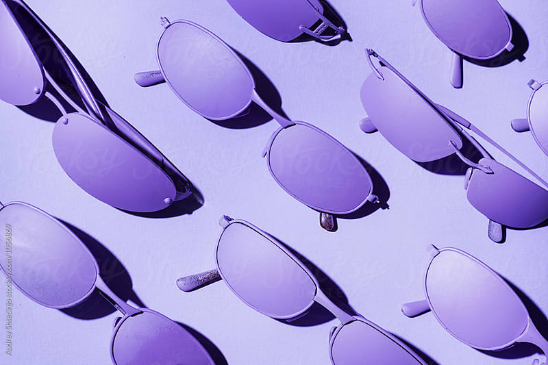 Purple/ violet sunglasses on purple/violet background.