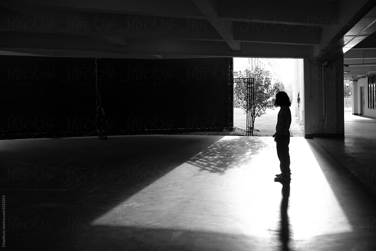 Silhouettes of people, in the special light and shadow of architecture