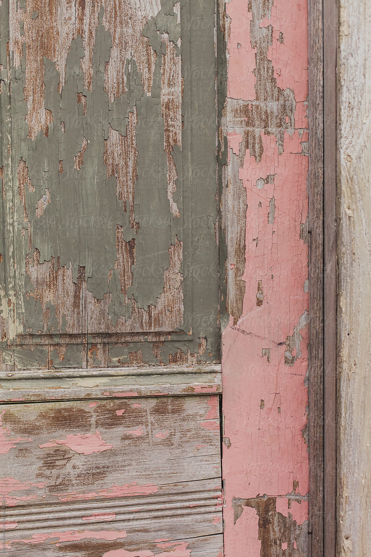 Close up of an old pink door with chipping paint