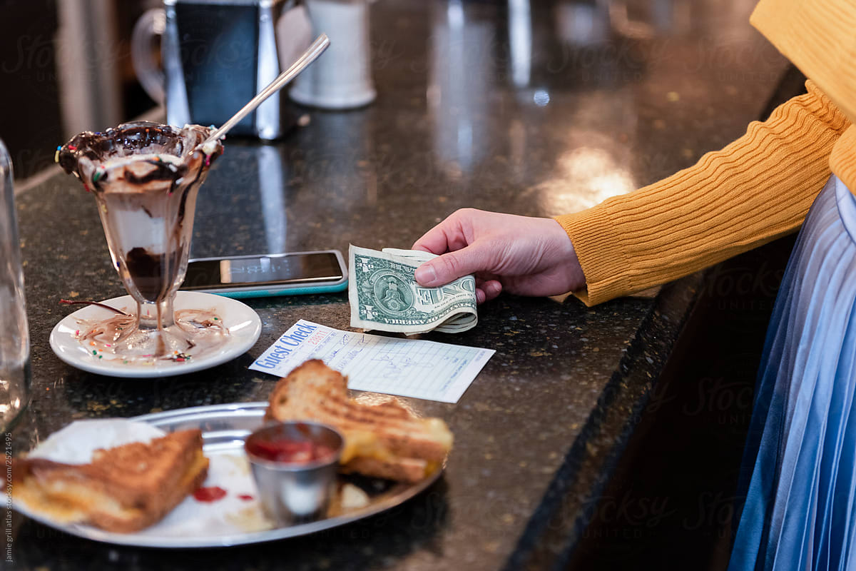 Woman paying at diner counter