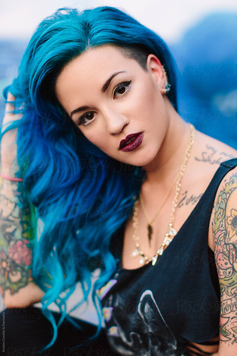 Vertical portrait of a beautiful mixed ethnicity women with blue dyed hair
