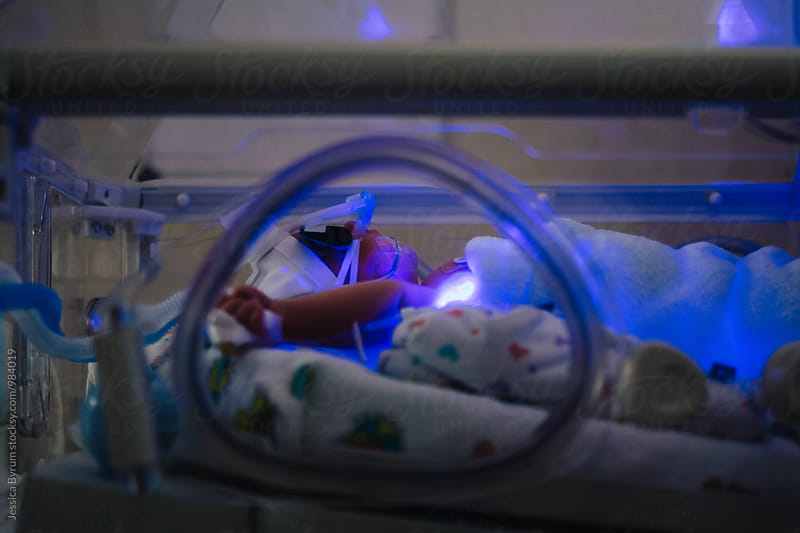Newborn baby boy in incubator