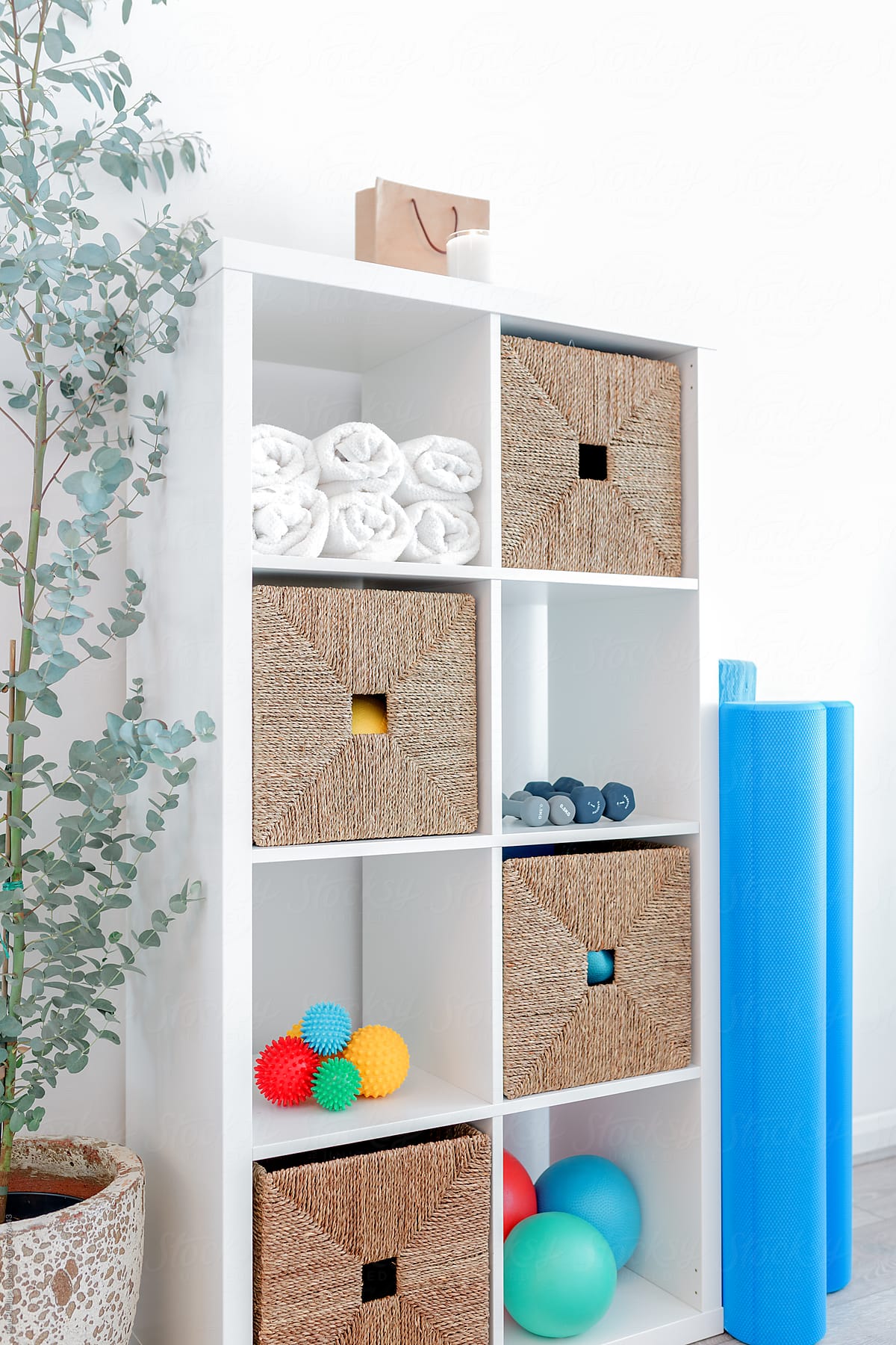 Corner of a Pilates studio with unit storing various items used for exercise