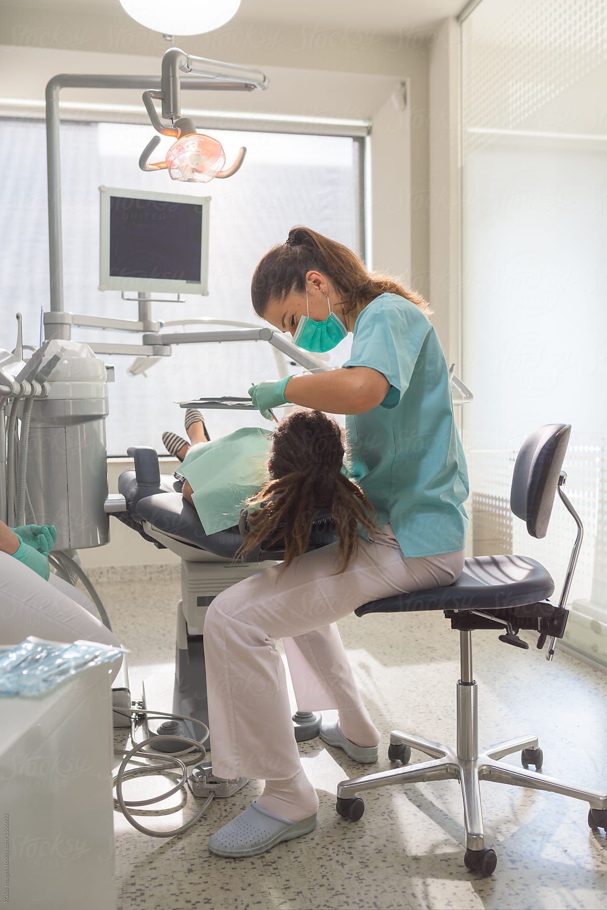 Dentist Treating Her Patient In Dental Office By Stocksy Contributor Ibex Media Stocksy
