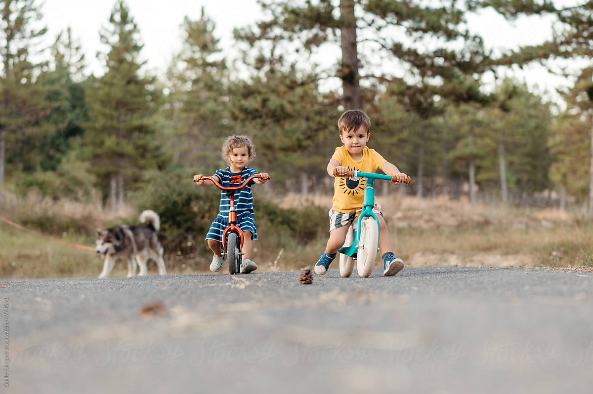 Children cycling balance bikes.