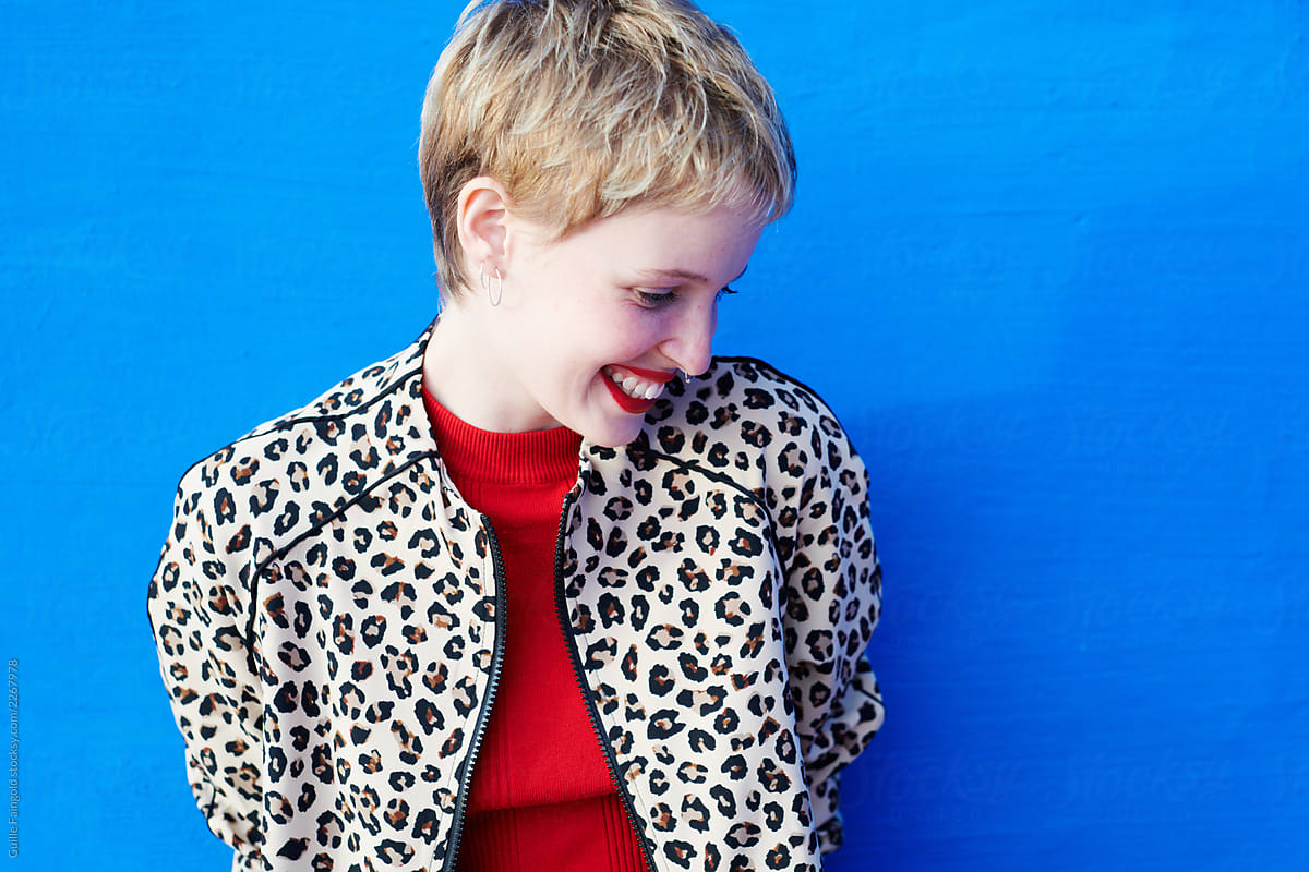 Laughing blonde woman in leopard jacket.