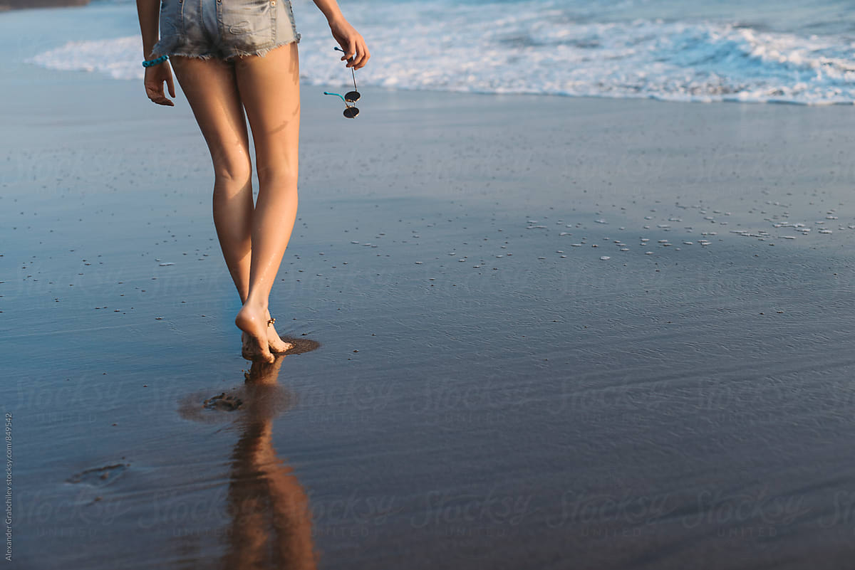 barefoot-walk-along-the-beach-at-sunset-by-stocksy-contributor