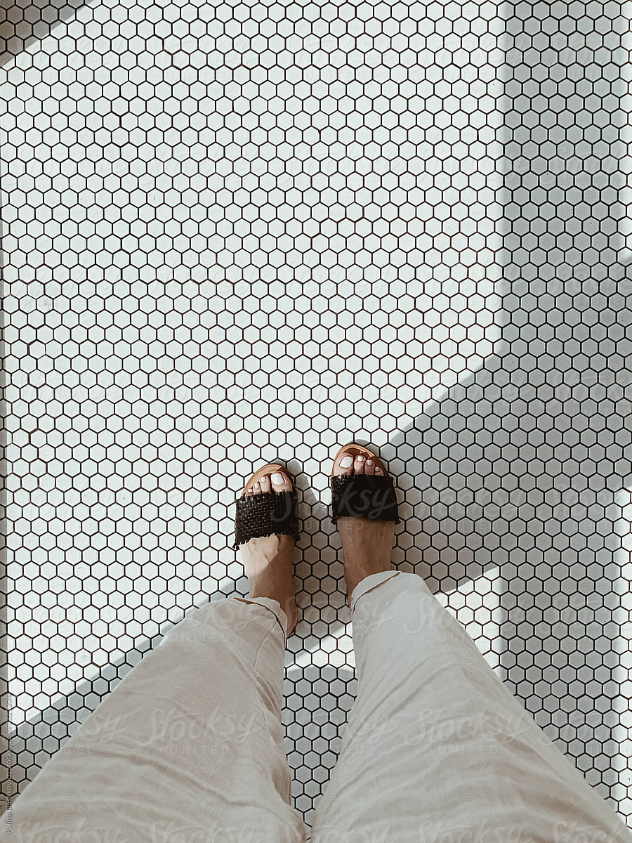 Minimal photo of woman standing on retro mosaic tile.
