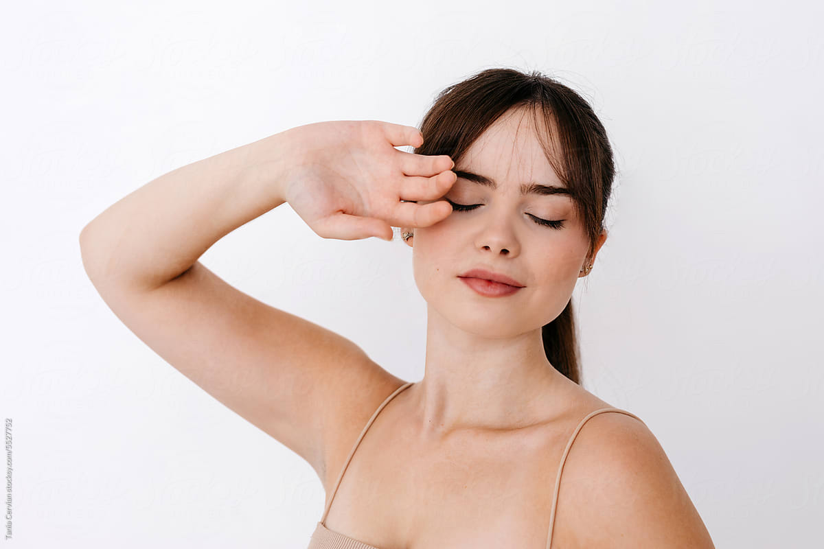 Calm stylish young woman in makeup with closed eyes