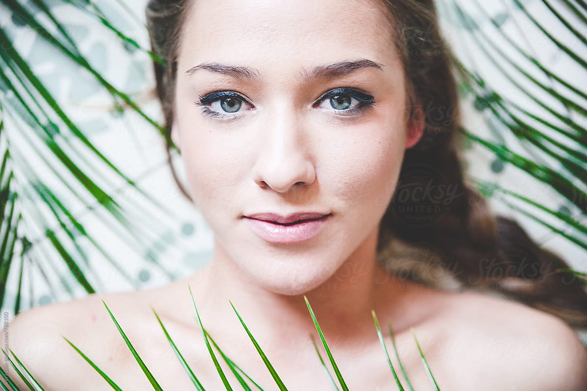 Youg Woman Lying On Floor And Looking At Camera By Stocksy