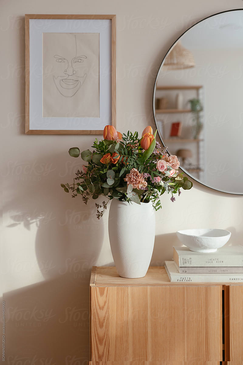 Gentle flowers in ceramic vase in room