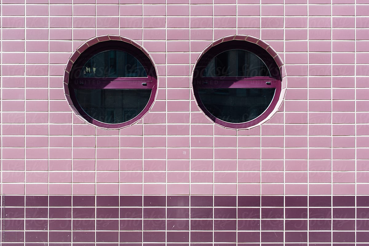 Round windows in pink tile wall