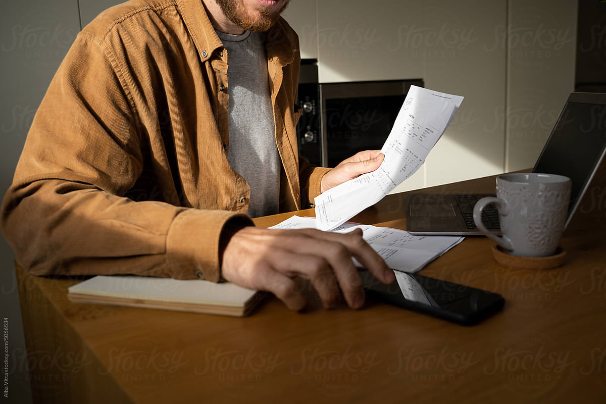 Man paying utility bills  from home