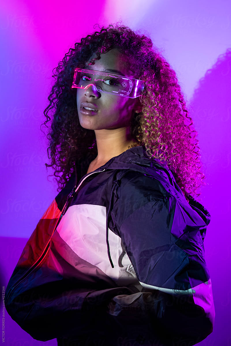 Stylish young woman with neon glasses