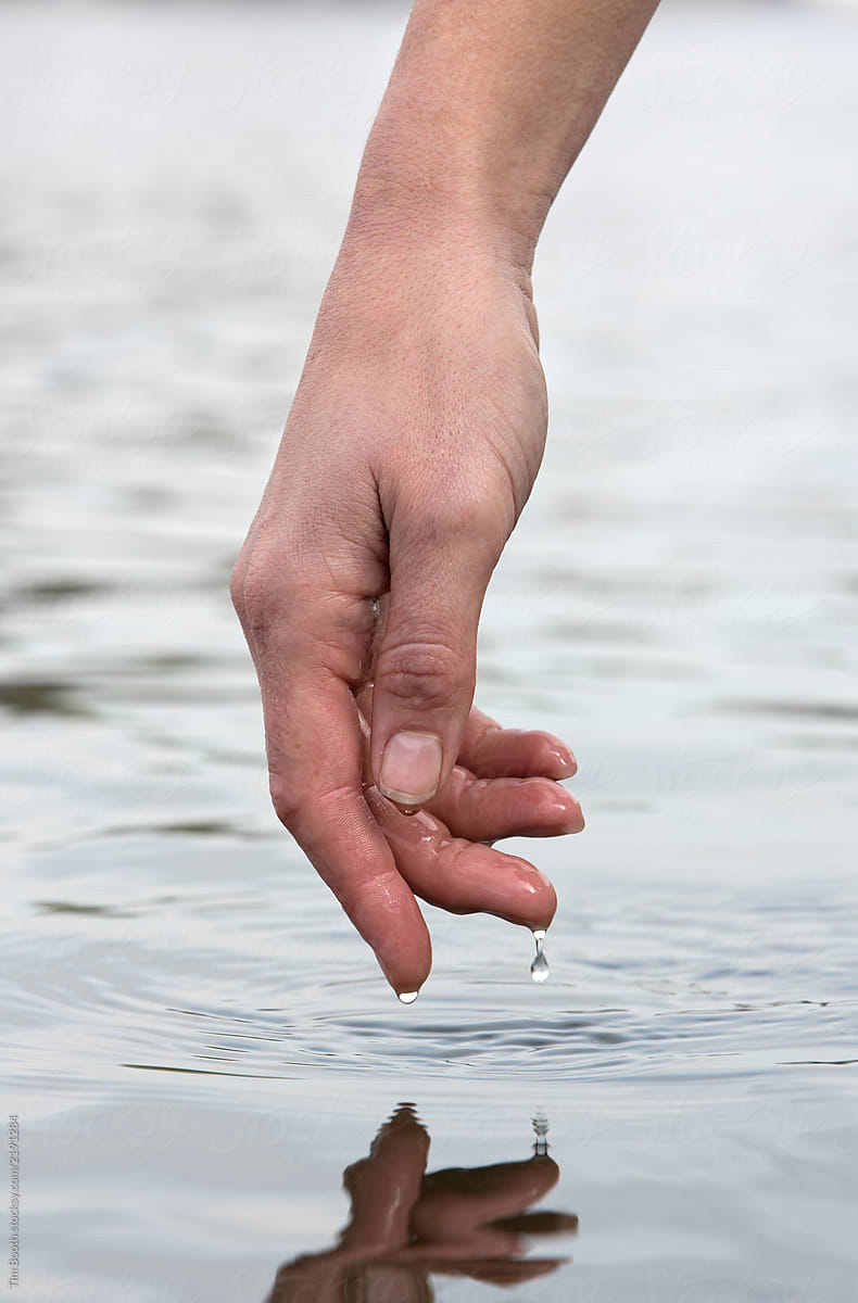 Close-up of a woman\'s hand above water