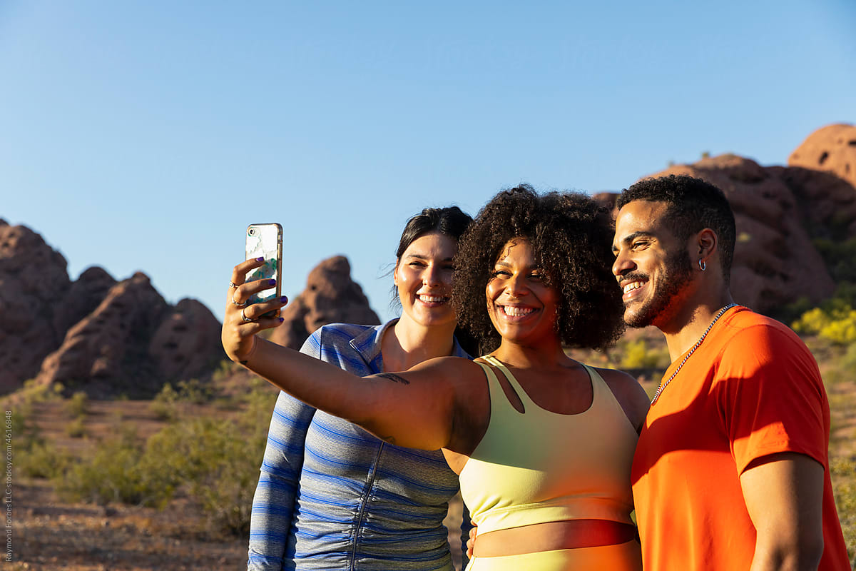Active Friends Hiking together in Arizona taking mobile phone selfie