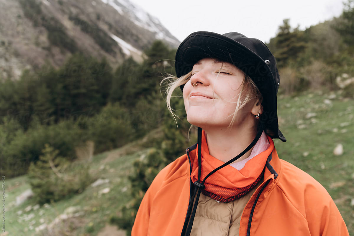 Female traveler enjoying fresh air in mountains