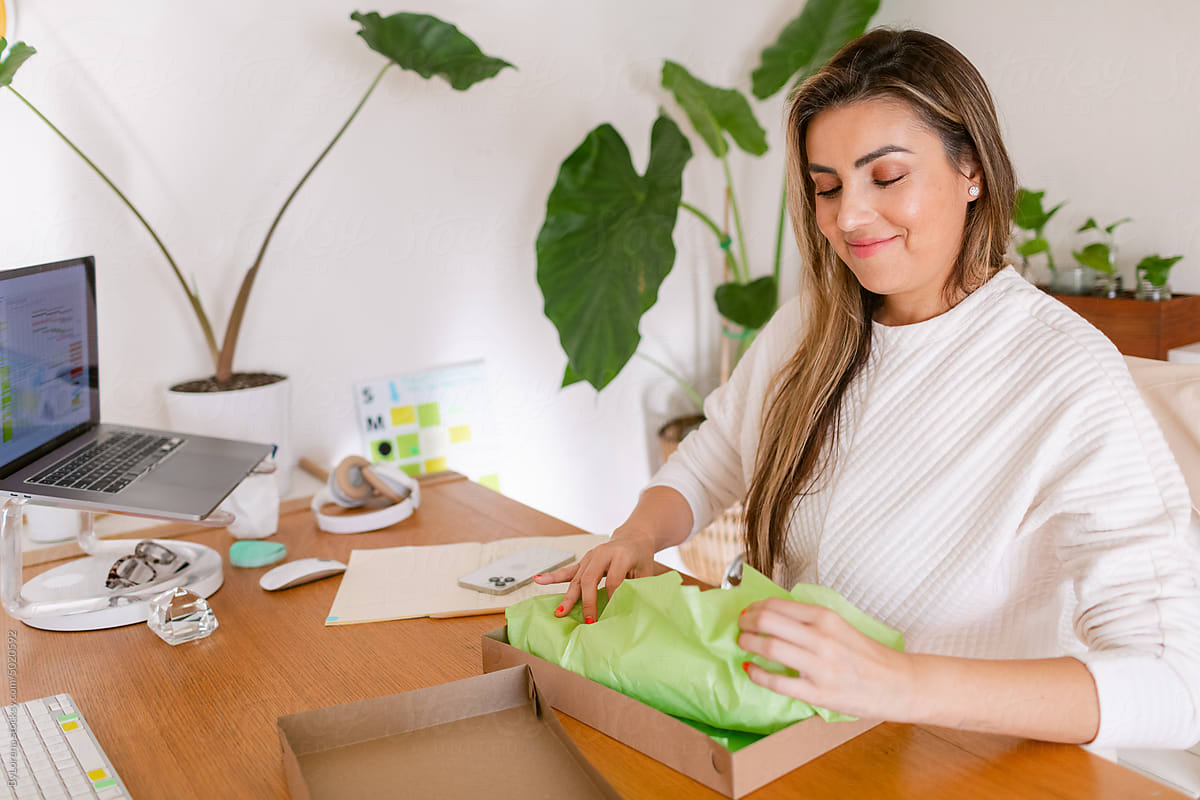 Woman packing order at office desk