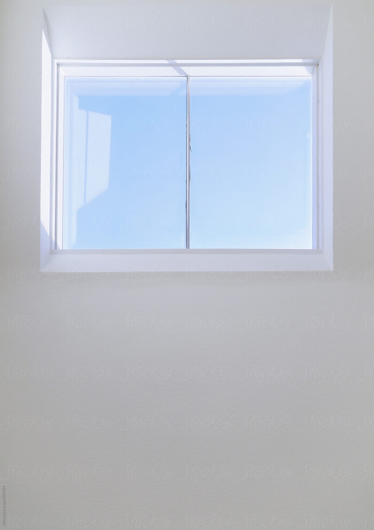 Clear blue sky through a glass window