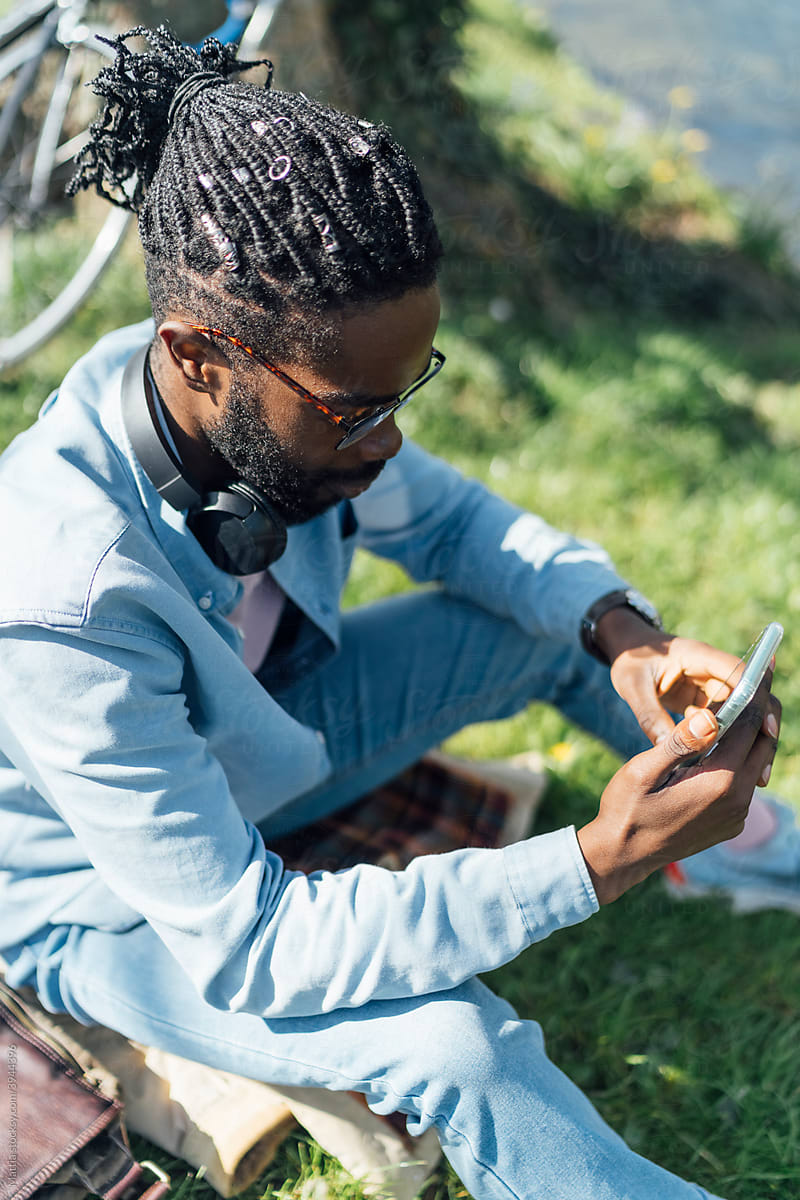 Black Man using A Mobile Outdoor