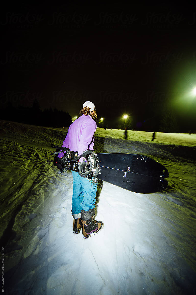 Snowboarder looks toward the track