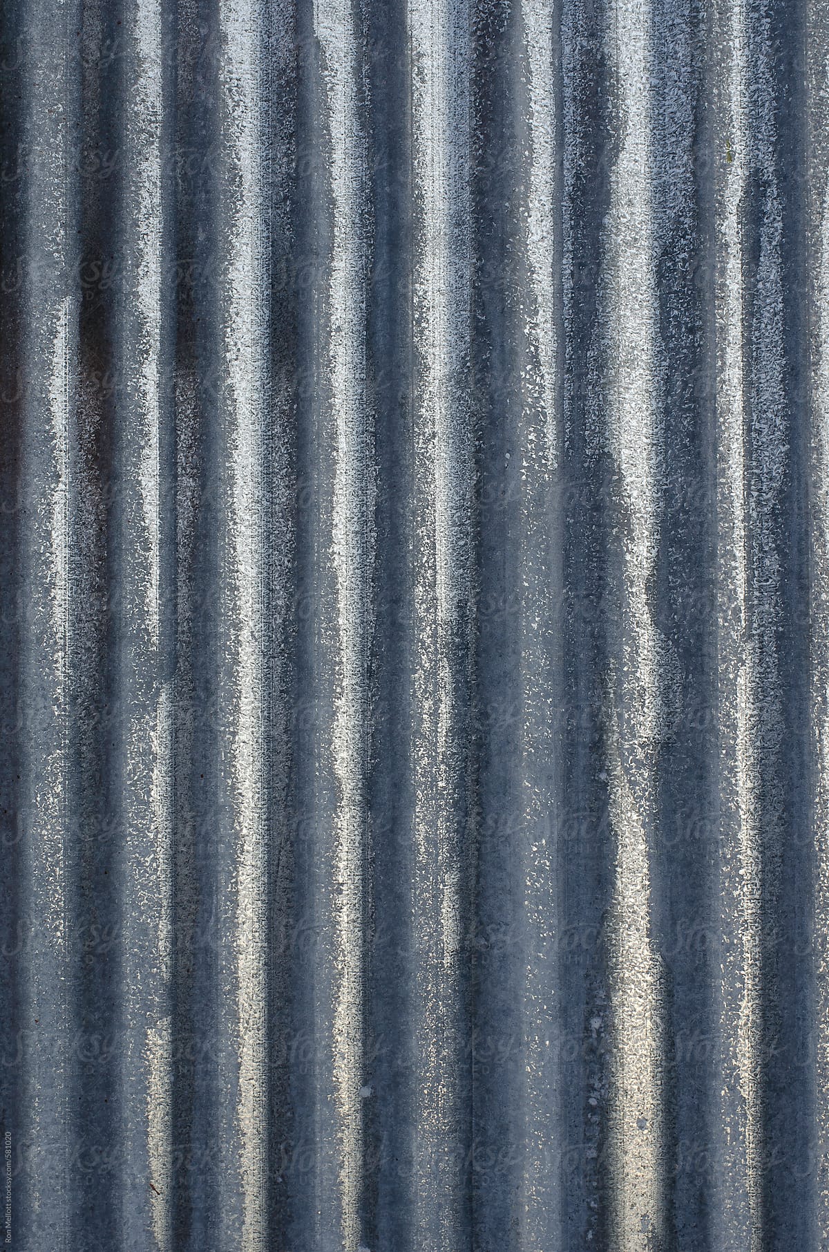 closeup microphotograph paint rust patterns corrugated metal siding