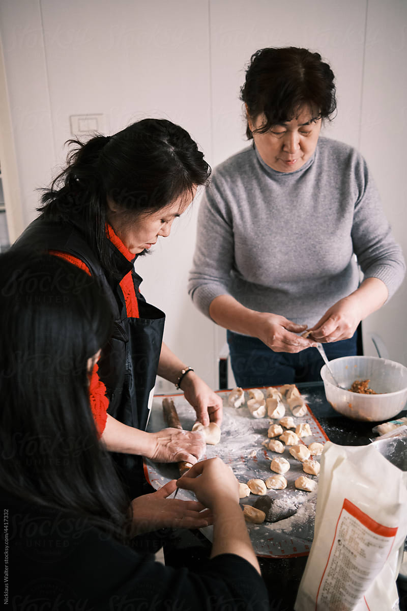 Chinese Women Make Dumplings At Home During Chinese New Year.