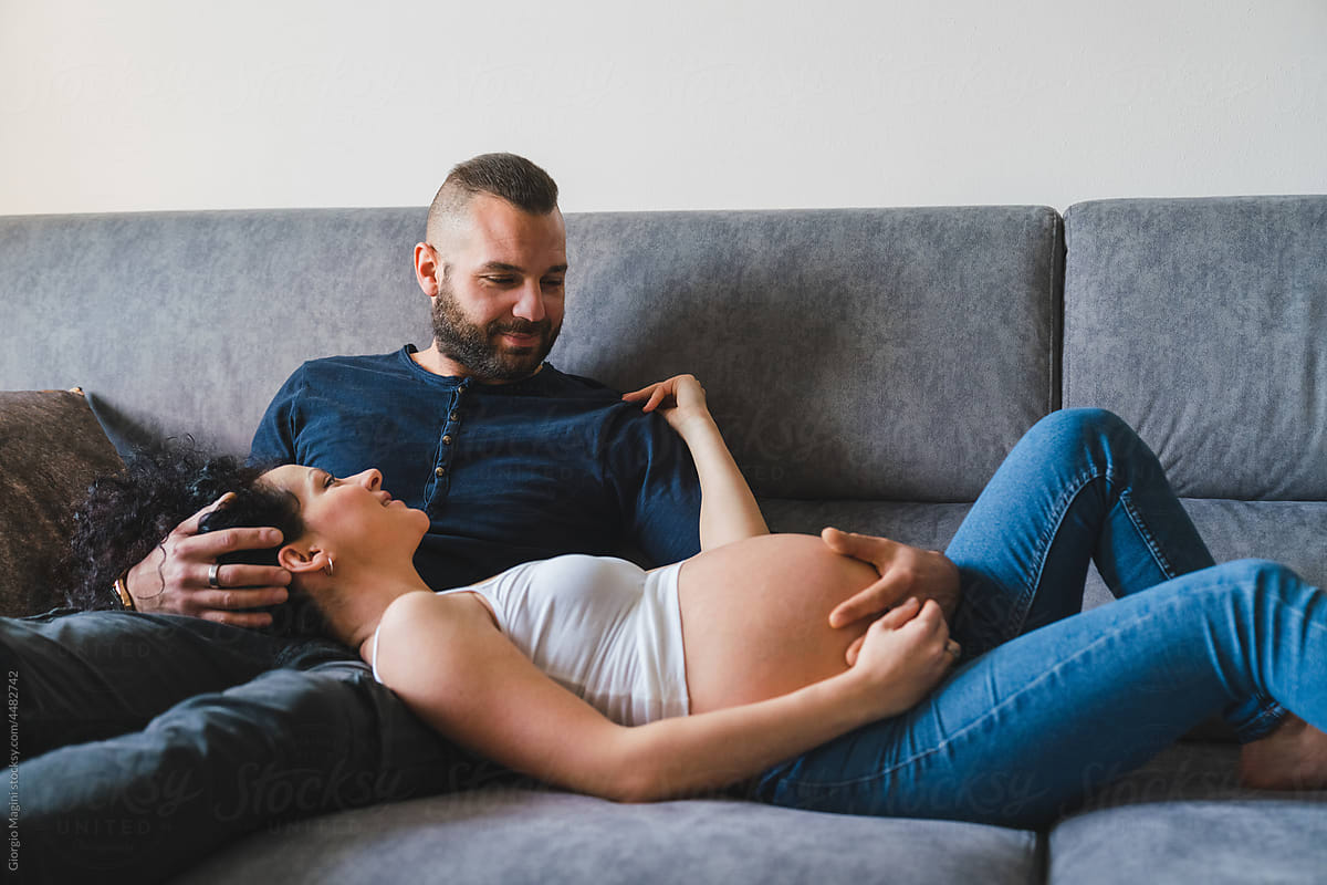 Adult Couple Expecting Baby Relaxing at Home