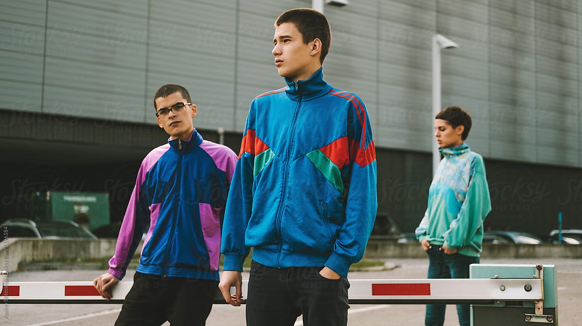 Young adolescents in colorful track suits from 90\'s in east Europe projects.
