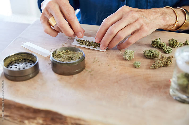 Senior woman\'s hands rolling a medical marijuana joint