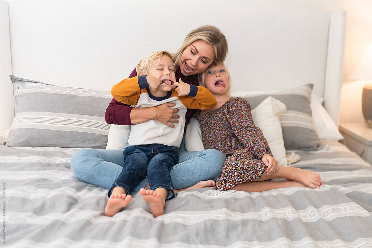 Mom makes silly faces with children