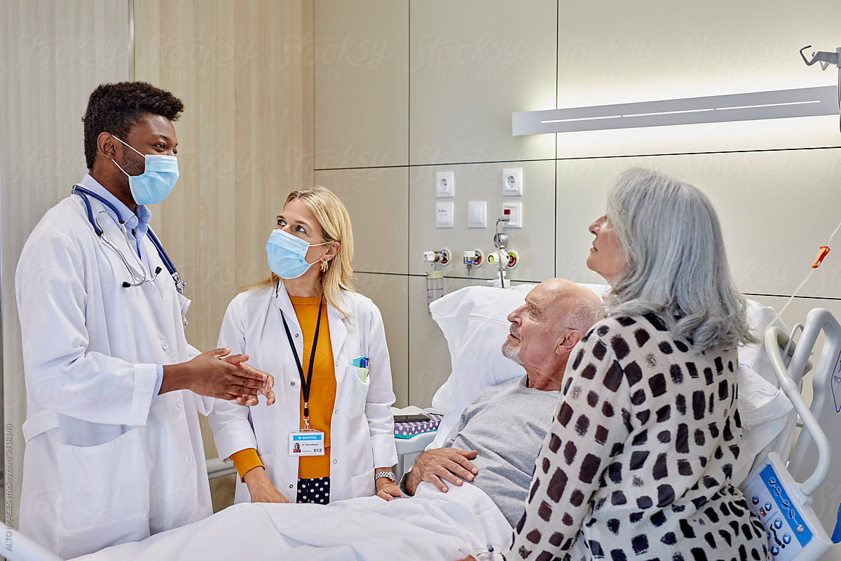 Doctors talking to senior patient