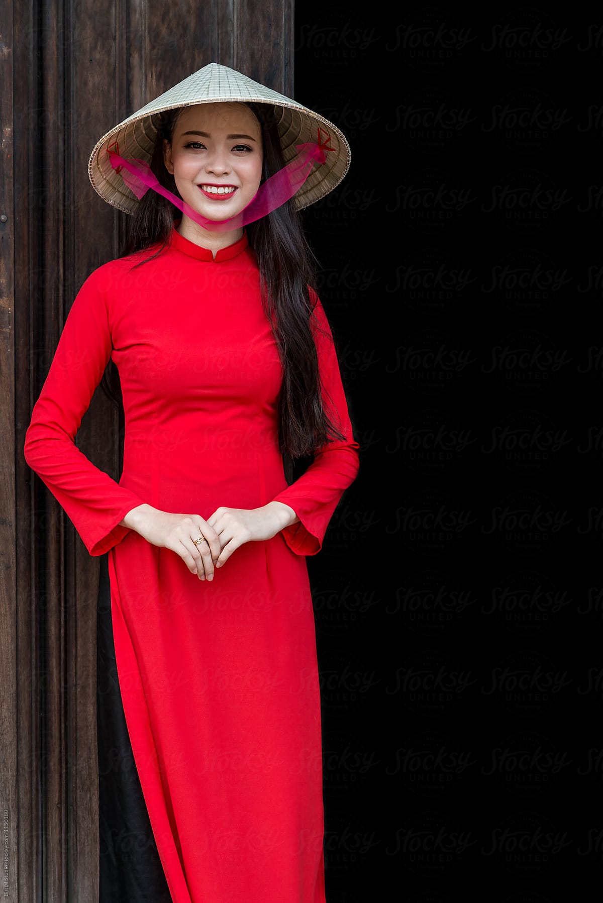 Traditionally dressed Vietnamese woman silhouetted in a 