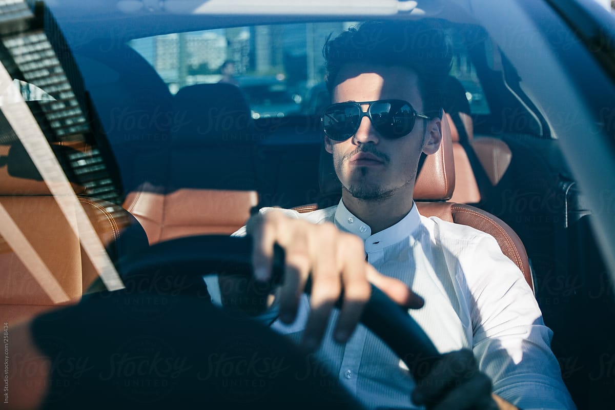 Young Man With Sunglasses Driving A Convertible Car by Stocksy Contributor  Inuk Studio - Stocksy