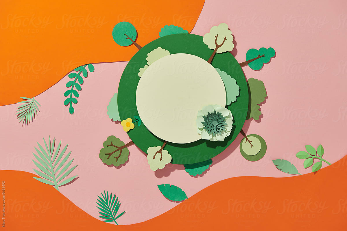 Green planet earth with trees and grass in paper cut style