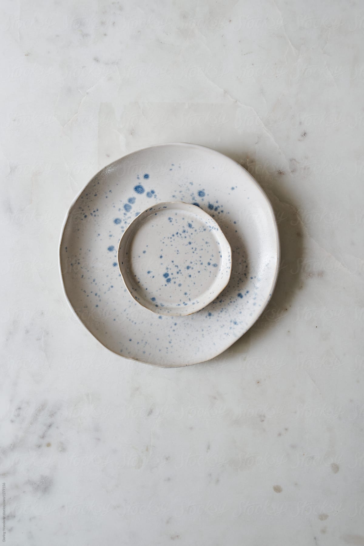Neutral minimalist unique handmade plate styling on marble table