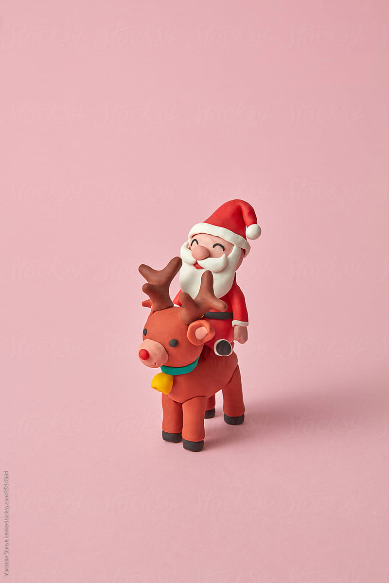 Handcraft plasticine Santa Claus ride a north deer.