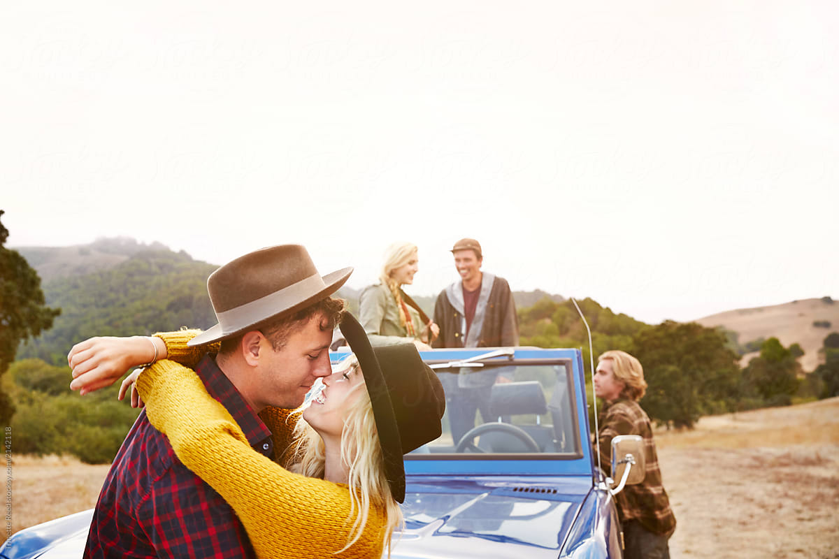 Portrait of couple kissing while on road trip