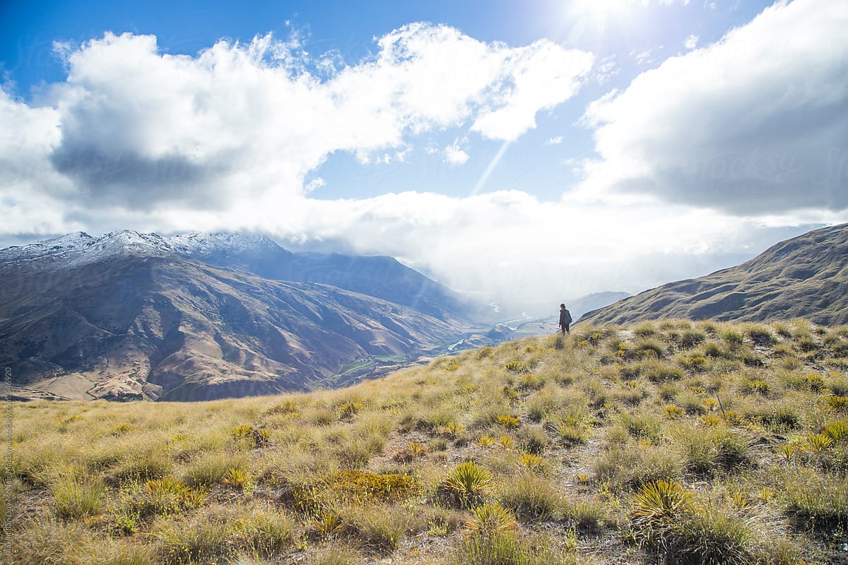 A woman hiking alone on a sunny day in New Zealand
