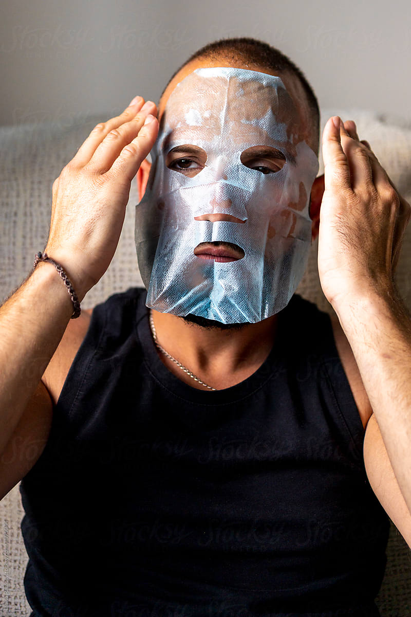 portrait of modern man with a facial mask
