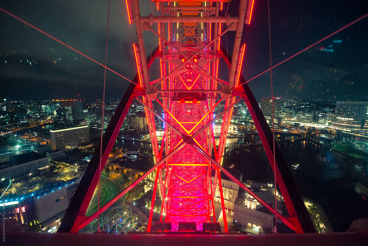 Ferris wheel ride with city view at night