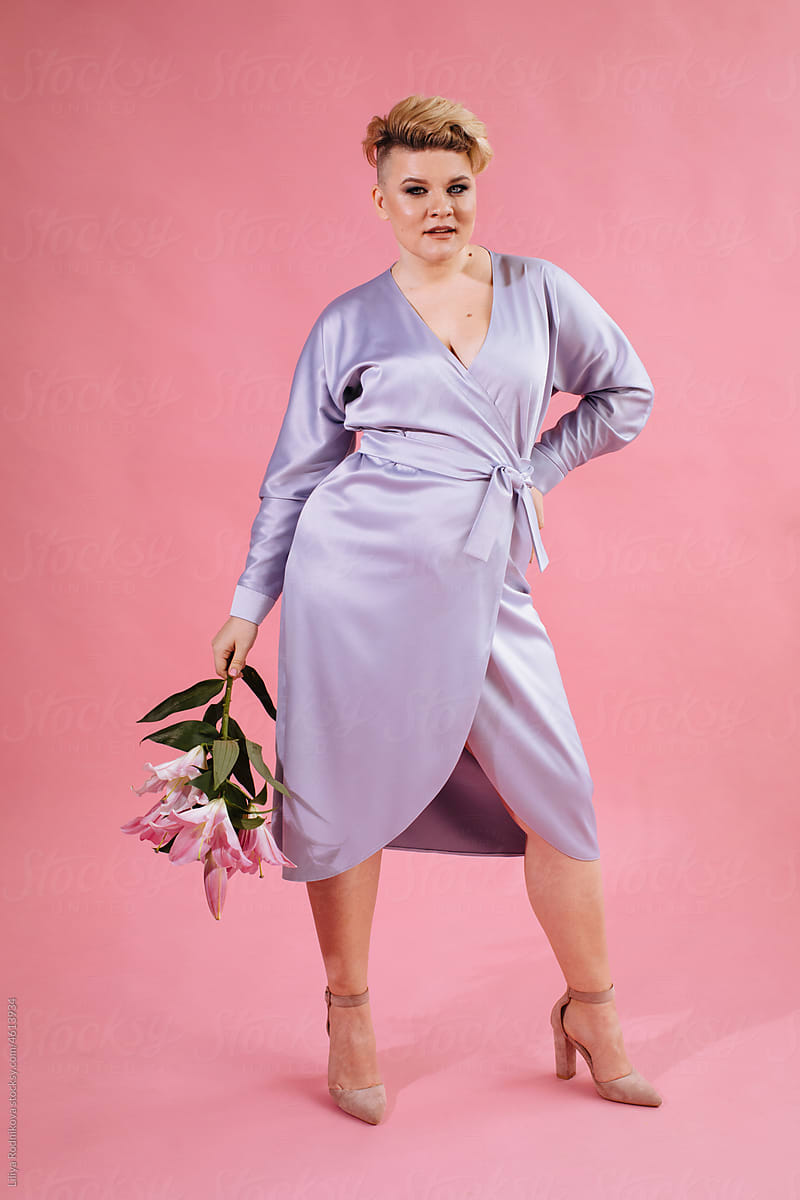 Trendy confident woman in lavender dress with flowers