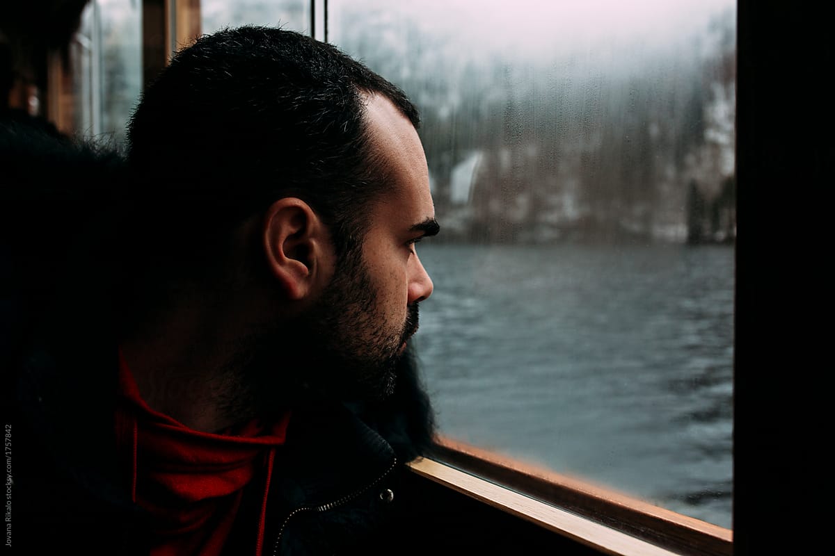Man looking through the boat window
